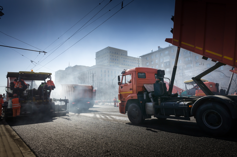 Asphalting,construction,works,with,commercial,repair,equipment,road,crews.,steam